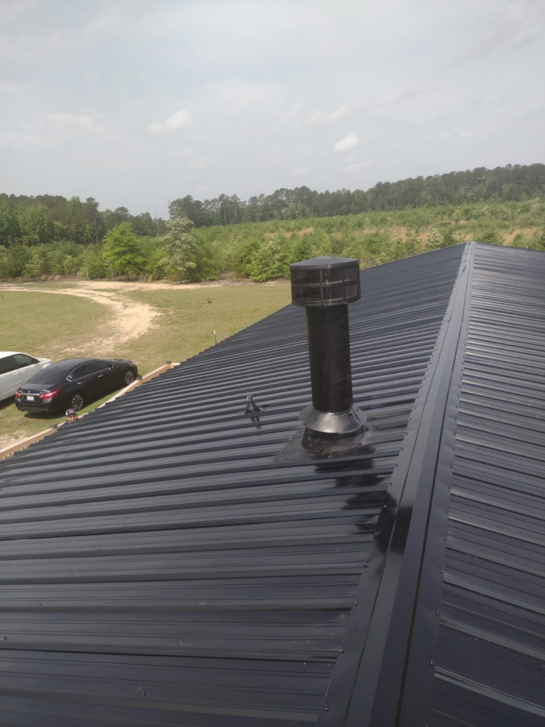 A glossy black metal roof was installed by Gator Metal Roofing.