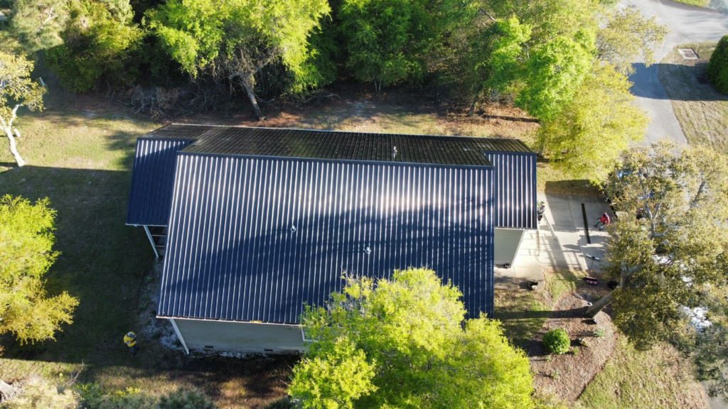 A dark blue metal roof was installed by Gator Metal Roofing on a residential property.