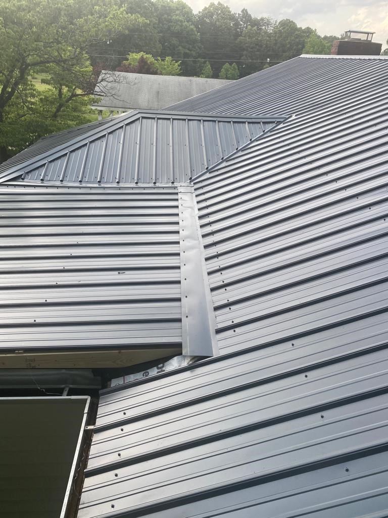 Several panels of standing seam metal roofing joined together to create a metal roof.